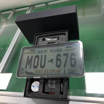 Close-up of the Stealth Blackout License Plate Cover showing the electronic components and installation details